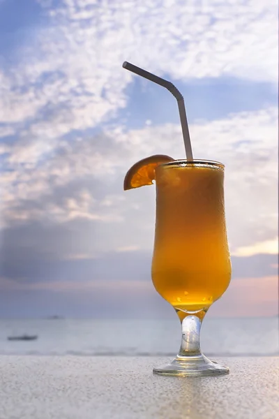 Glass of orange juice on sky background — Stock Photo, Image