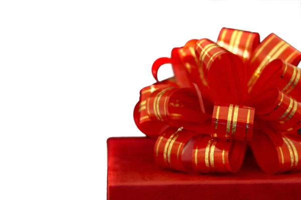 Red ribbon and gift box over white — Stock Photo, Image