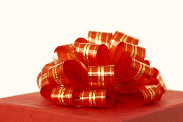 Red ribbon and gift box over white background — Stock Photo, Image