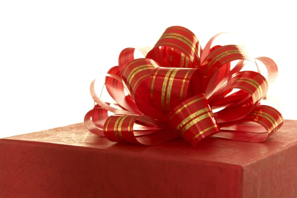 Red ribbon and gift box over white background — Stock Photo, Image