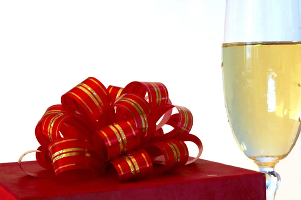 Red gift box and glass of champagne — Stock Photo, Image