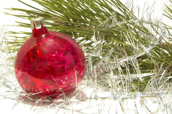 Christmas ball and tinsel over white — Stock Photo, Image