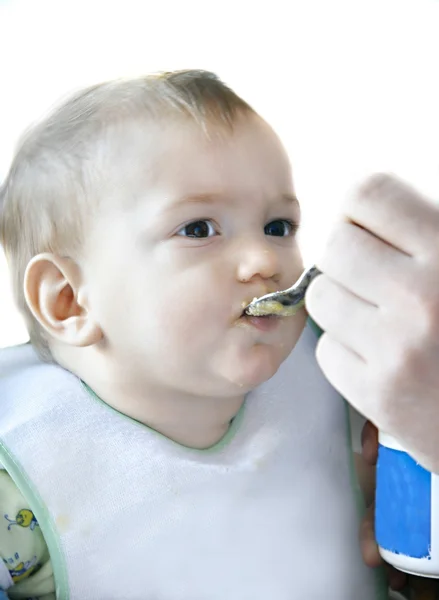 Eating baby boy over white, focus on eyes Royalty Free Stock Images