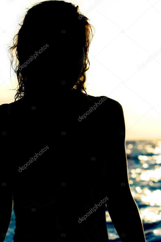 female silhouette on blurred sea background