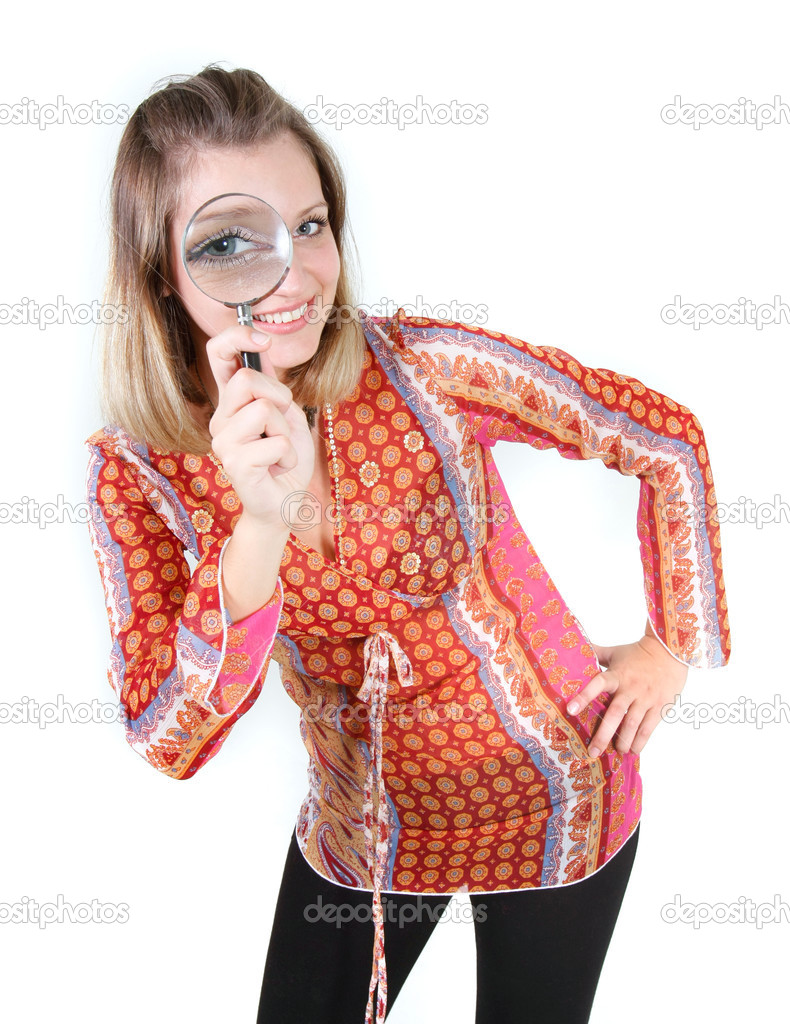 girl looking through magnifier glass over white