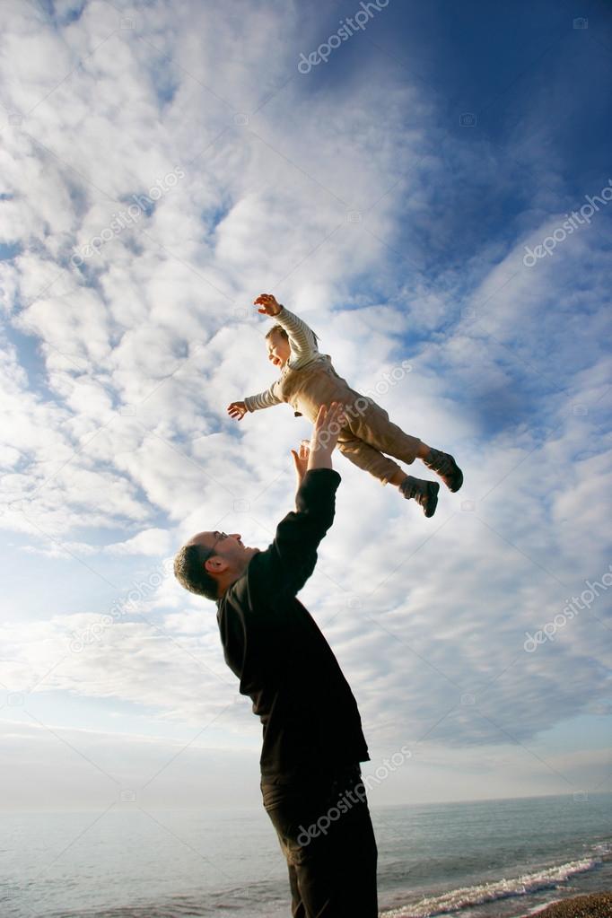 Father and son playing on beach