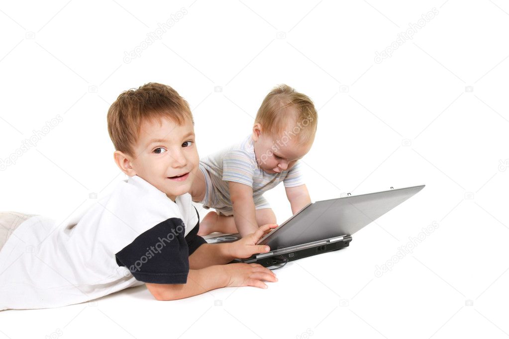 Two children with laptop over white