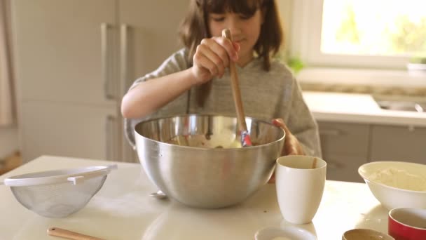 Child girl preparing a mix for cake in a mug, dessert baking, cooking with kids at home — Stock Video