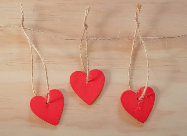 3 červené štítky ve tvaru srdce nebo cenovky na dřevěném pozadí. promo, sleva nebo prodej koncept, prostor pro text, promo nebo reklama — Stock fotografie