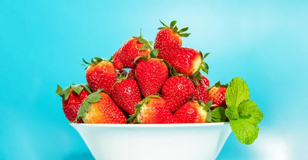 Freshly picked organic strawberry isolated over blue background, healthy eating — Stock Photo, Image