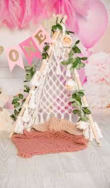 pink and white decoration for a 1st birthday cake smash studio photo shoot with balloons, paper decor, cake and topper. High quality photo