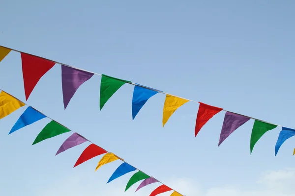 Multi colored flags hanging in the sky — Stock Photo, Image