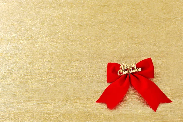 Boże Narodzenie czerwony kokarda ozdoba na złotym tle — Zdjęcie stockowe
