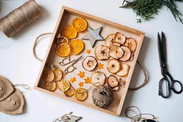 Eco friendly zero waste dried orange slices and DIY tools and stuff on the table. Handmade dried orange for Christmas decorations and Christmas presents. — Stock Photo, Image