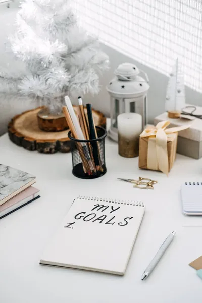 New goals, New year resolution. Handwritten Text My goals in open notepad on the table. Start new year, planning and setting goals for the next year