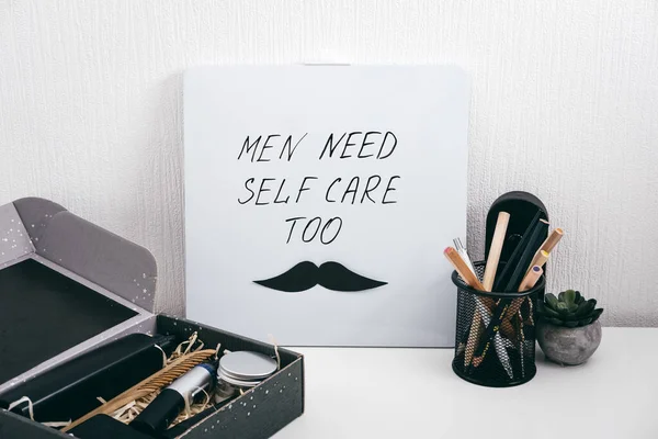 Men self care kit black box with male beauty care products and devices and letter board with text Men need self care too. Man self care package or gift box for boyfriend, husband, father or brother