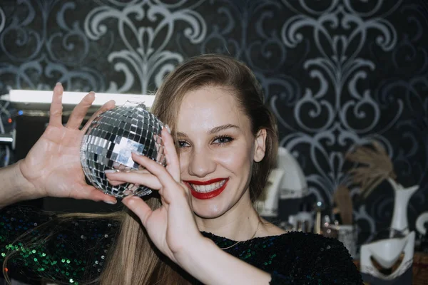 Nightlife, New year eve party, New year celebration. Portrait of young beautiful woman and disco ball — Fotografia de Stock