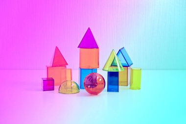 Metaverse, future, digital technology concept. Neon bright constructor blocks on abstract multicolored neon lights background.