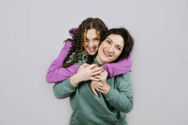 Mutlu anne ve genç kızın portresi birlikte zaman geçiriyor. Genç kız annesine sarılıyor ve birlikte eğleniyor.