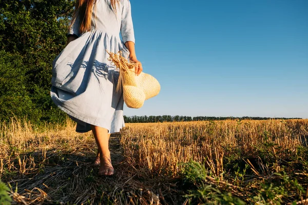 Physical and mental well-being. Faceless portrait of woman in linen dress enjoys nature on sunset summer nature background. — Stok fotoğraf