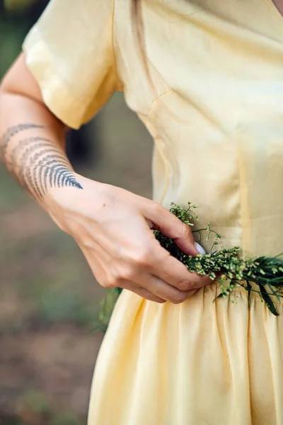 Midsummer solstice ritual. Celebrating summer solstice. Significance of the solstice in Paganism. Woman with herbs wreath on nature background.