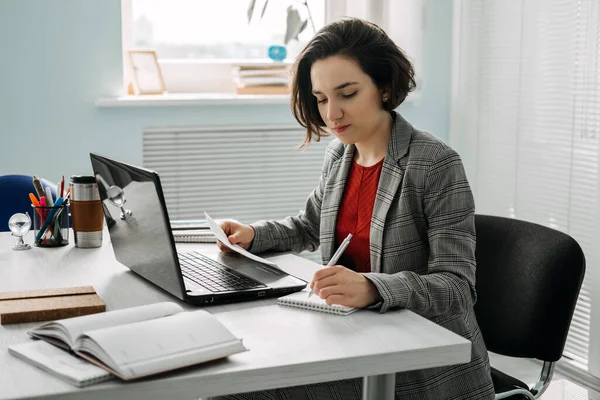 Woman-Owned Business, Successful Business Woman, Female Entrepreneurs. Confident young businesswoman working in modern office