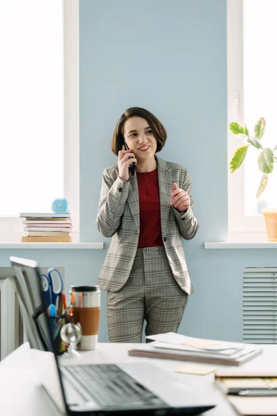 Legal Business Consultant, Legal Advisor, female lawyer confident young businesswoman talking on cell phone in modern office