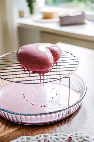 Mousse Cake. Mirror Glaze Cake. Process of making heart shape mousse cake with pink mirror glaze. Frozen mirror icing on the cake.