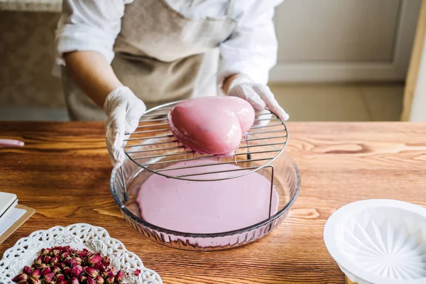 Mousse Cake. Mirror Glaze Cake. Process of making heart shape mousse cake with pink mirror glaze. Frozen mirror icing on the cake.
