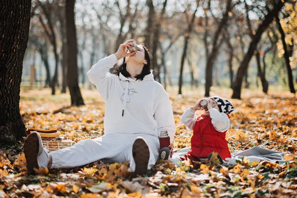 stock image Family Fall Activities. Happy family single mom and toddler baby girl playing outdoors in fall park. Little girl and her mother in the autumn park.