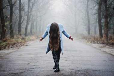 Nervous breakdown, mental breakdown. Exited woman with long fluttering hair express emotions on nature background