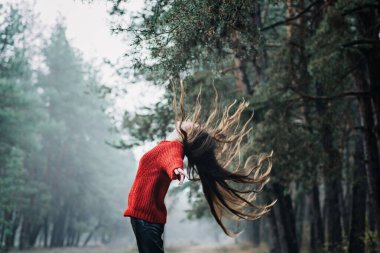 Nervous breakdown, mental breakdown. Exited woman with long fluttering hair express emotions on nature background