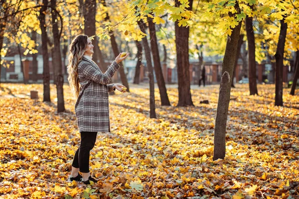 Autumn skin care beauty health tips. Autumn Skincare haircare tips. Happy beautiful blonde woman with long hair having fun in fall sunny city park