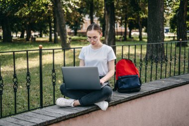 Freelancing for beginners, working as freelancer, Flexible working hours. Young candid woman freelancer working with laptop and documents in cafe, coworking workplace
