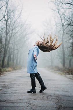 Mindfulness-based cognitive therapy, Mindfulness practices. Young woman with long fluttering hair relaxing in forest
