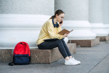 Time Management For Students, Outdoor portrait of girl with laptop, papers and books near college, university