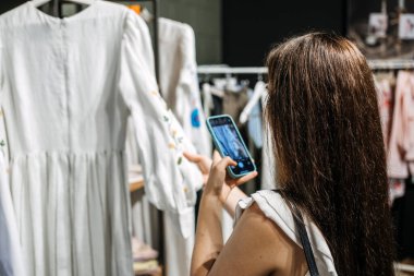 Ecommerce and sell online. Woman taking picture of clothes in the shop. Second hand, Selling used clothes
