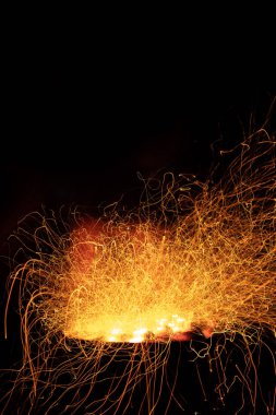Campfire flame sparks long exposure isolated on black background. Fire sparkles long exposure isolated on black background.