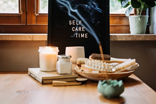 Self-care, Wellness concept. Letter board text Self Care Time, aroma sticks, body and self-care handmade cosmetics and natural organic beauty product.