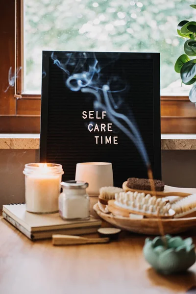 Self-care, Wellness concept. Letter board text Self Care Time, aroma sticks, body and self-care handmade cosmetics and natural organic beauty product.