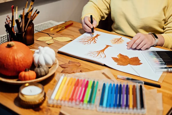 Art therapy for mental health recovery, Making Art Helps Improve Mental Health. Creativity and Recovery. Faceless portrait of woman drawing autumn trees with markers.