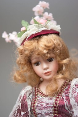 Vintage porcelain face girl doll. Close up shot, shallow depth of field, no people.