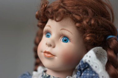 Vintage porcelain face girl doll. Close up shot, shallow depth of field, no people.