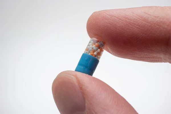 Small Medicine Medicament Capsule Half Blue Half Transparent Held Fingers — Stock Photo, Image
