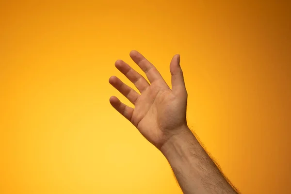 Open Caucasian Male Hand Close Studio Shot Isolated Orange Background — Stockfoto