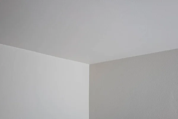 White interior apartment walls. Corner shot of 2 sidewalls and ceiling meeting. No people