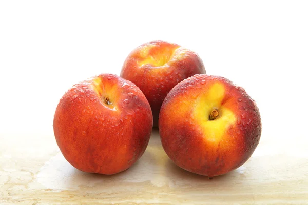 Group of three fresh peaches — Stock Fotó