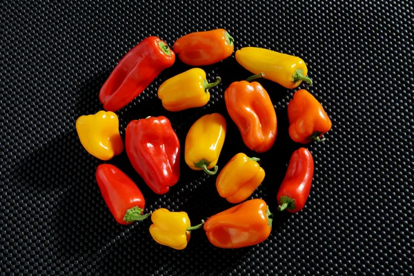 Mixed red, orange and yellow peppers — Stock Photo, Image