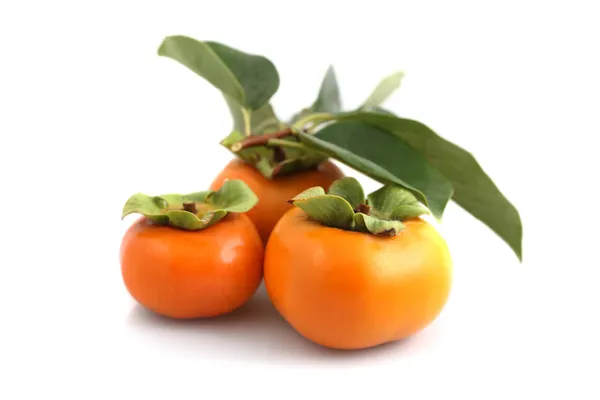 Three fresh persimmons — Stock Photo, Image