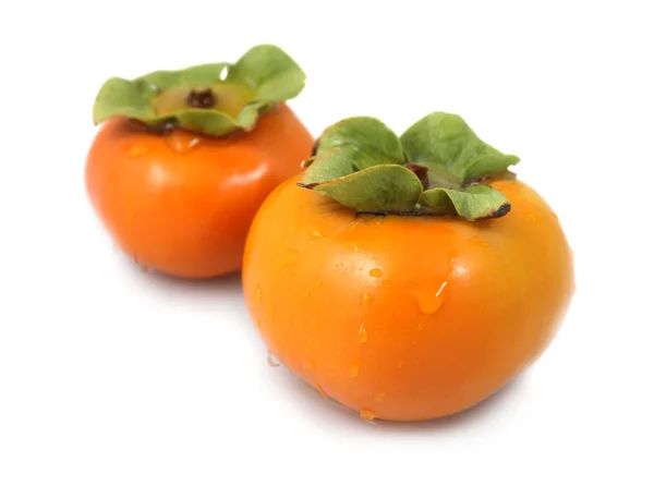 Pair of fresh organic persimmons — Stock Photo, Image